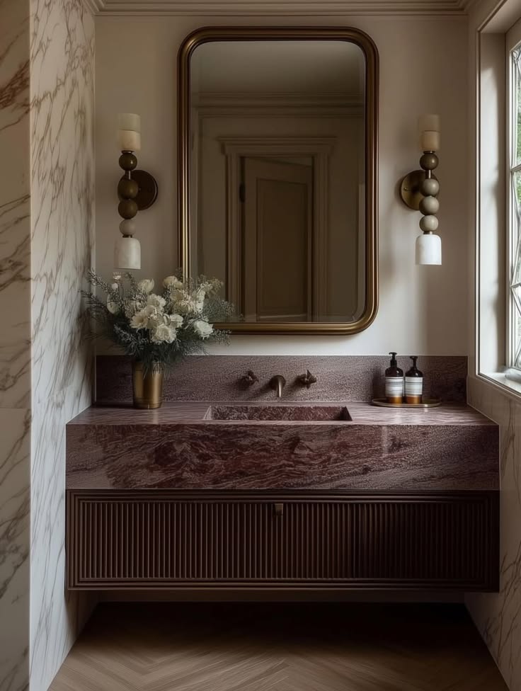 Elegant bathroom interior with mirror, marble and warm lighting